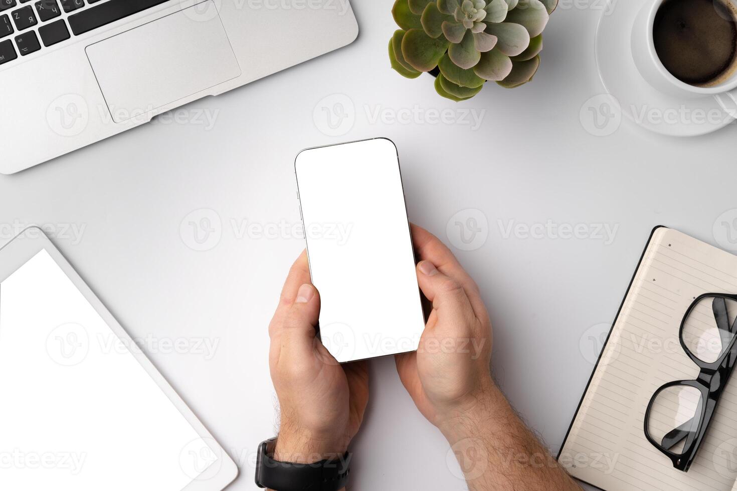 Man using blank smartphone on workplace desk, top view photo