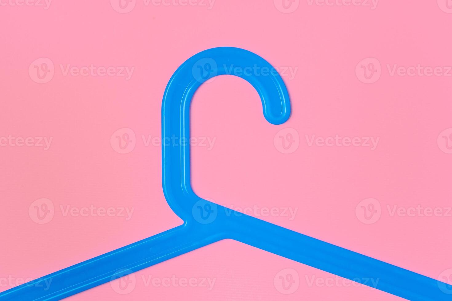 Flat lay composition with empty hangers on pink background photo