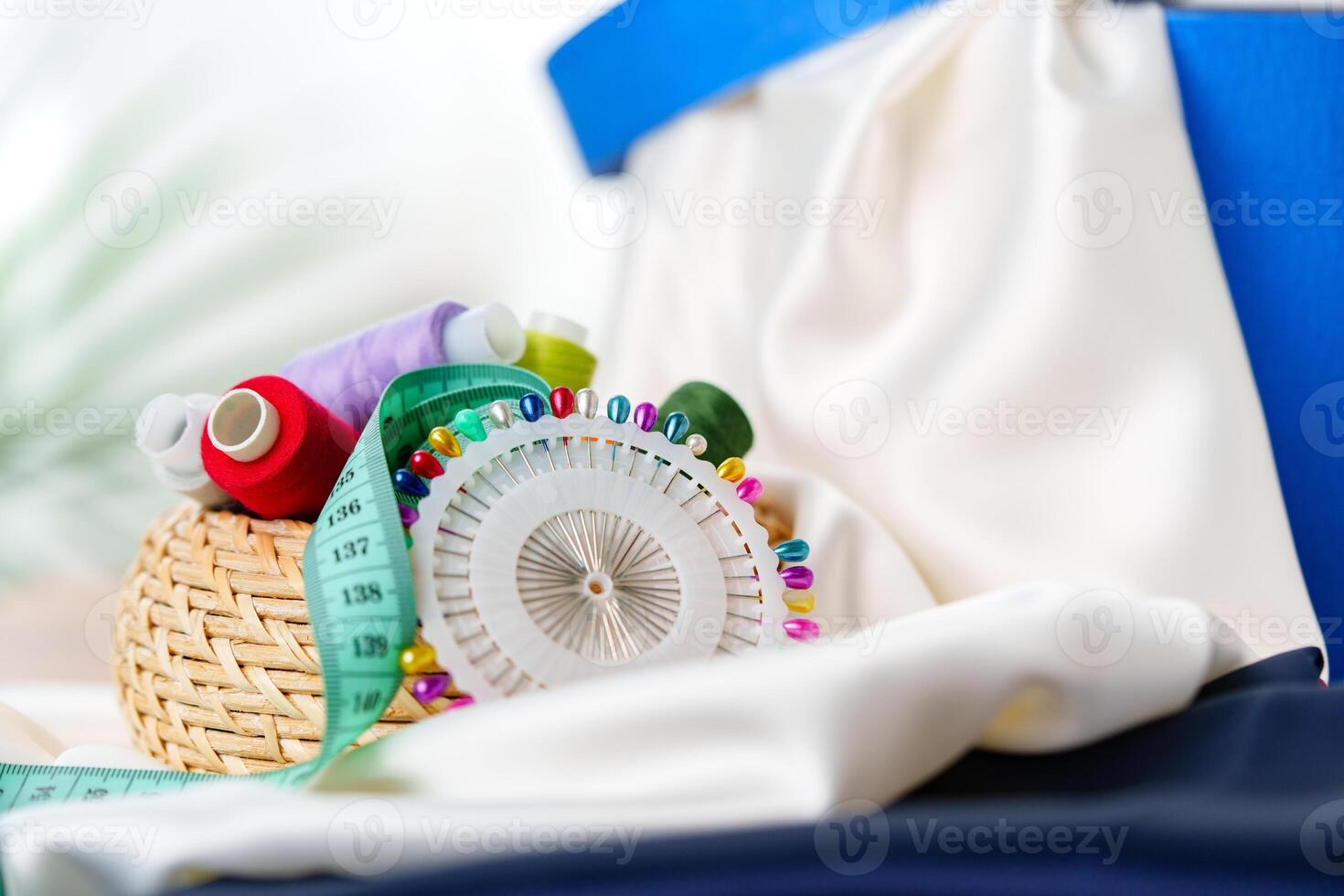 Crafting supplies arranged on a wooden table with colorful threads photo