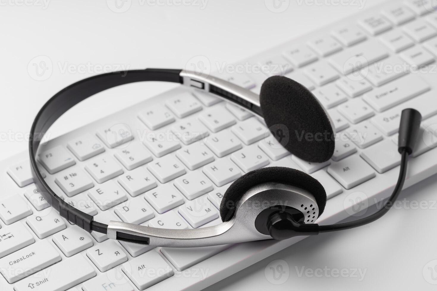 Headset on a laptop keyboard on office table photo