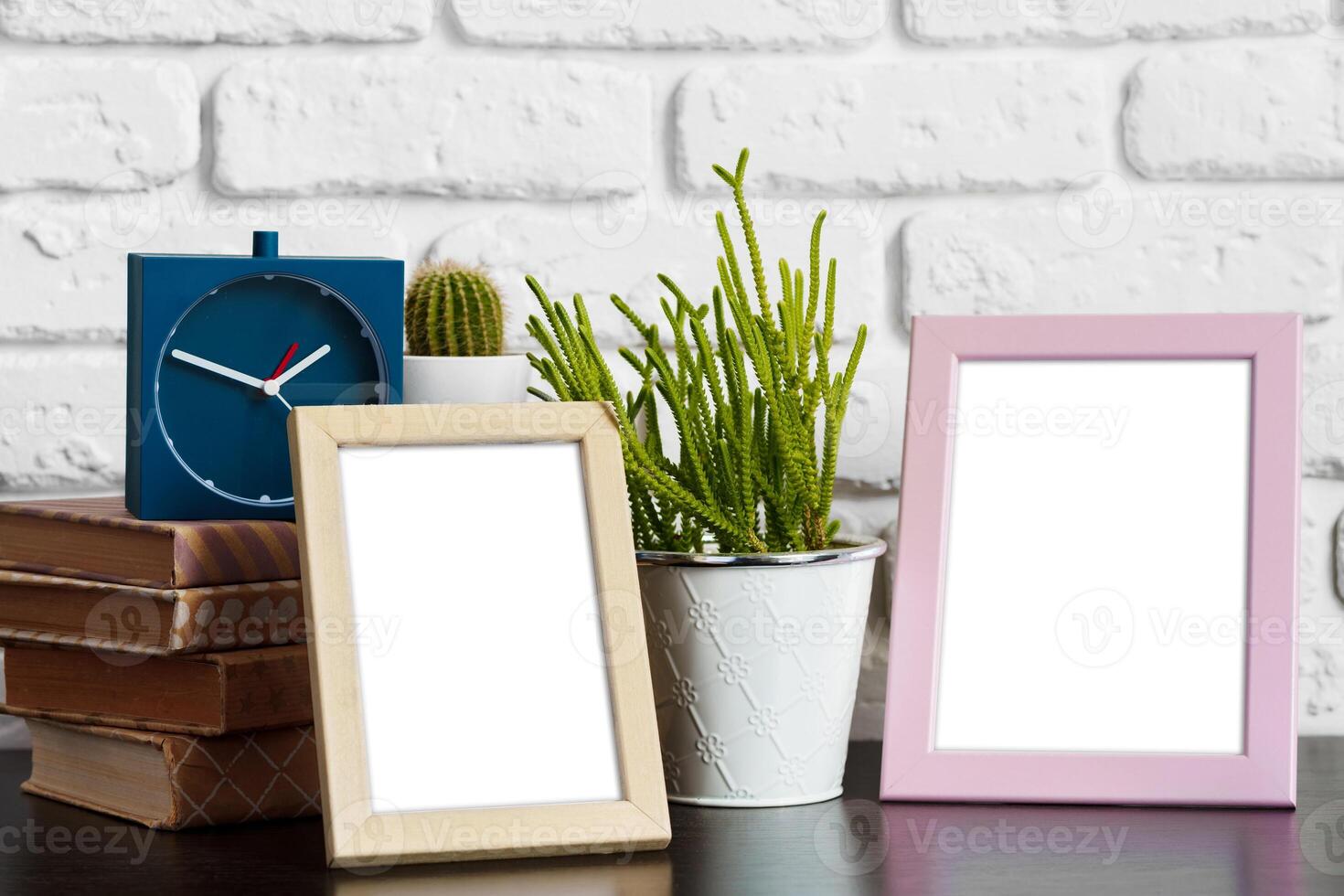 Books with picture frame on wooden table photo