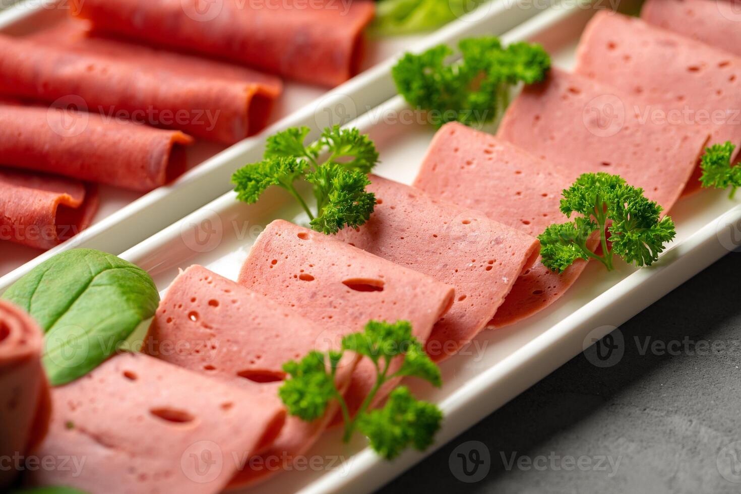 Platter of fresh meat cold cuts with vegetables. photo