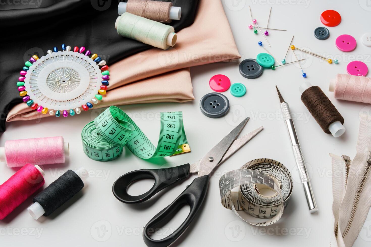 Crafting essentials for sewing projects displayed on a table with fabric, threads, and tools photo