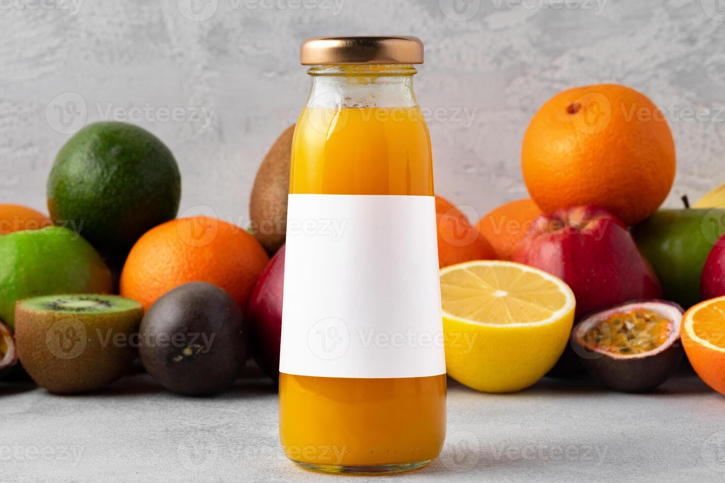 Various fruits and freshly squeezed fruits juice in bottle on gray background photo