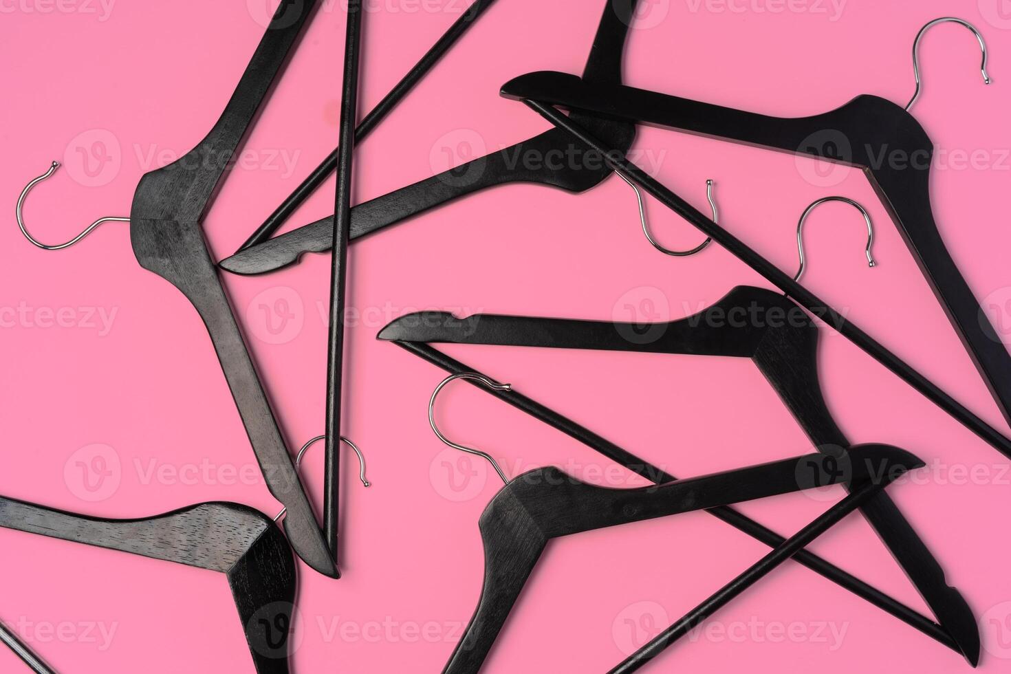 Flat lay composition with empty hangers on pink background photo