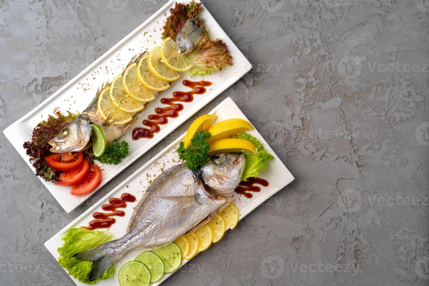 Fresh sea fish with lemon on plate photo