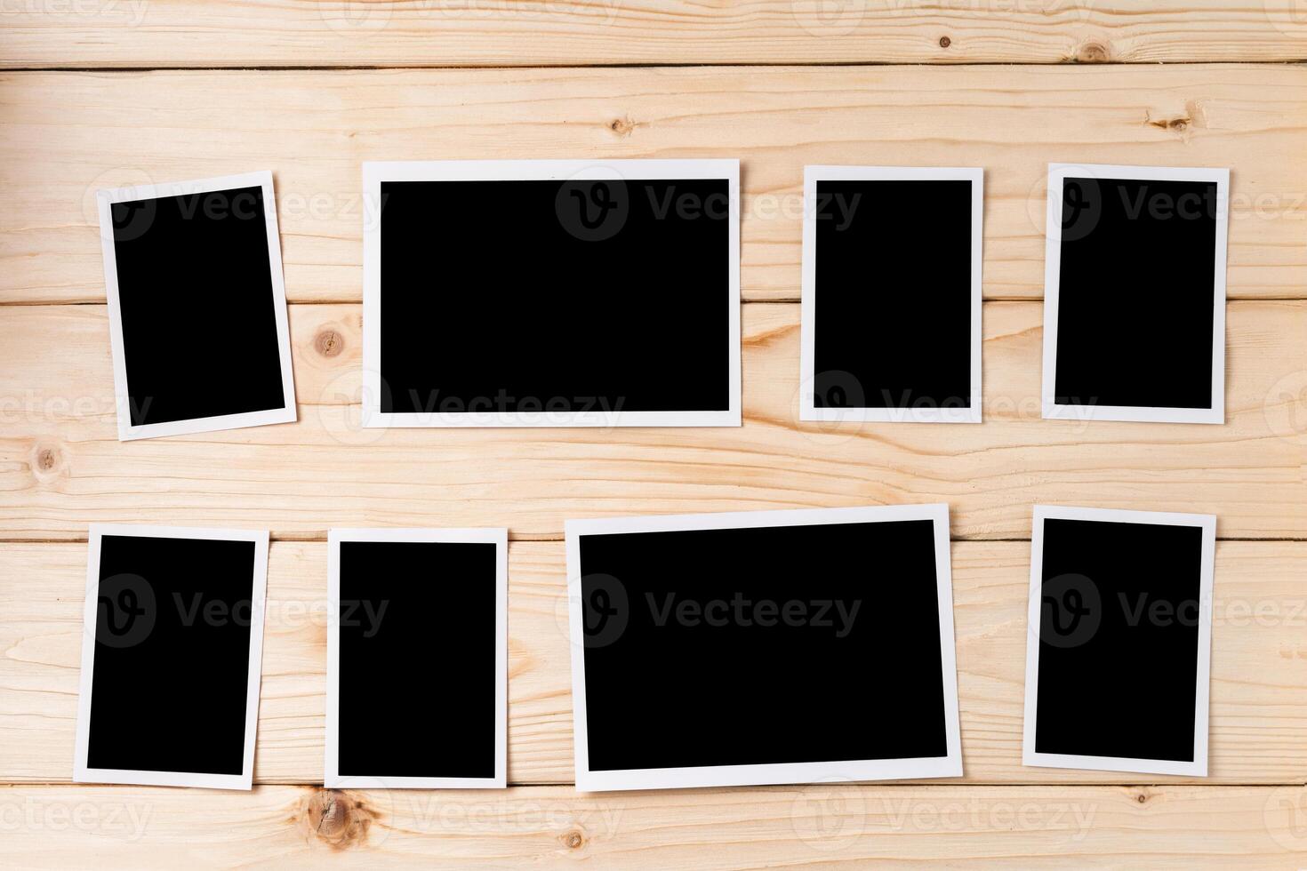 Blank photo frames for your photos on wooden background