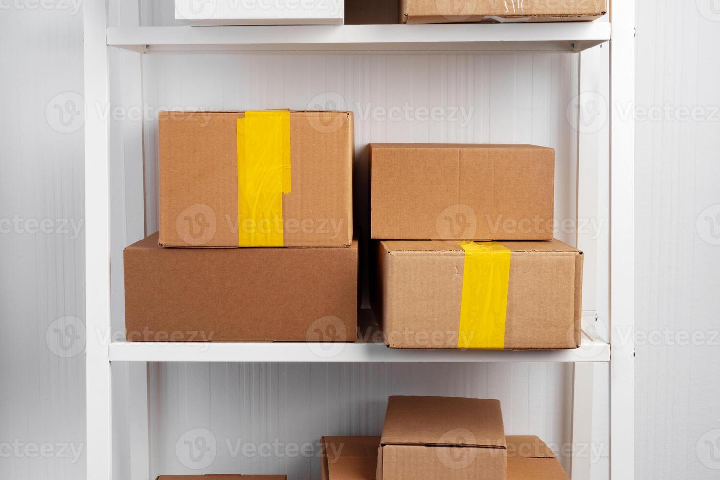 Stack of cardboard package boxes on wooden rack photo