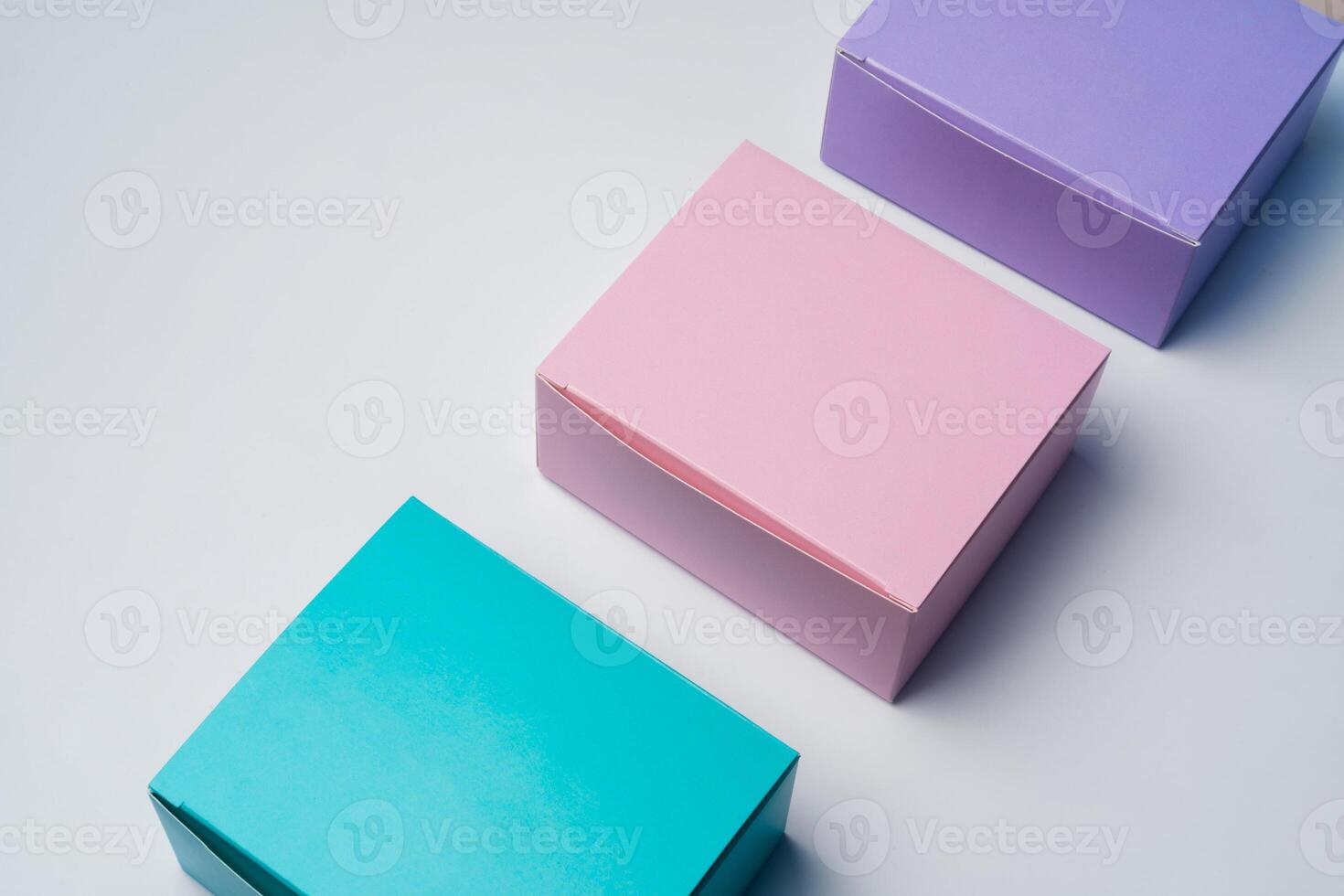 Pile of colorful cardboard boxes on white background photo