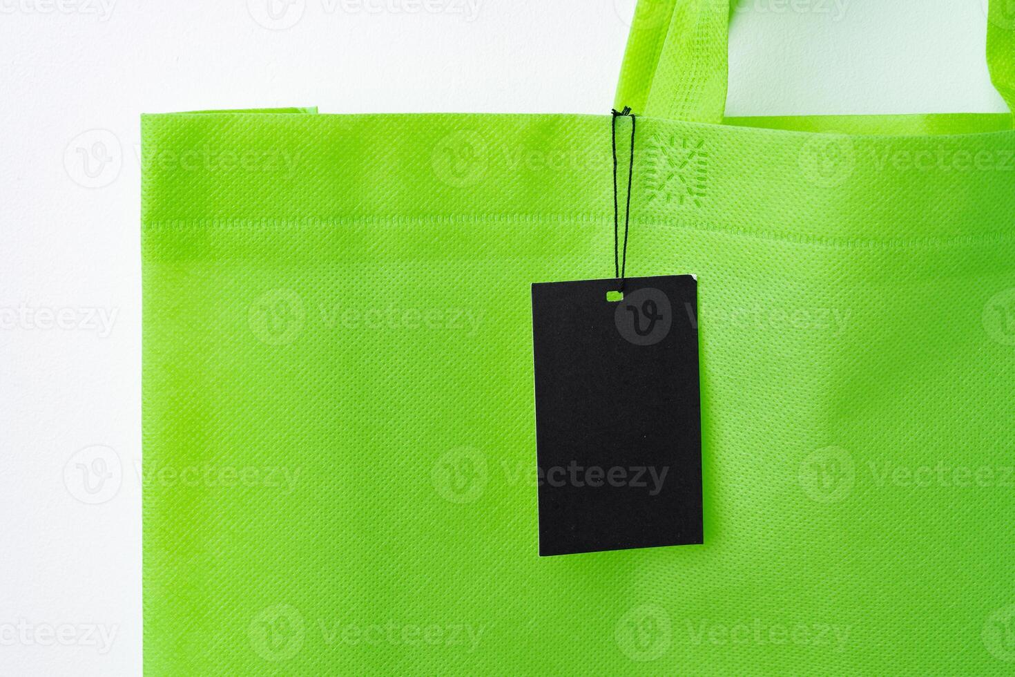 Blank paper tag with shopper paperbag on white background photo