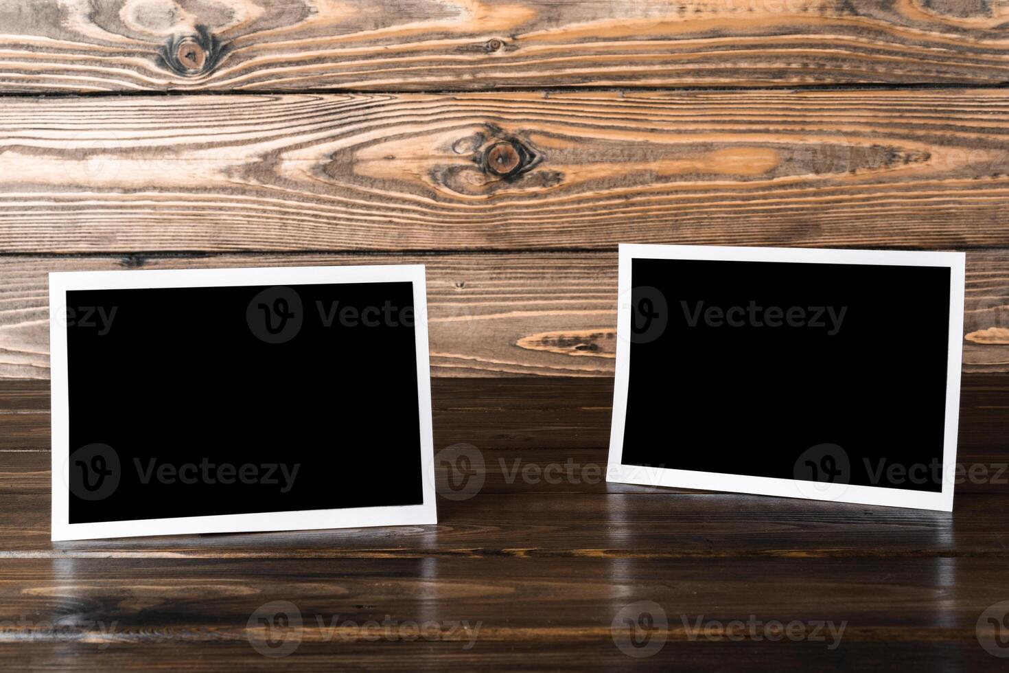 Blank photo frames for your photos on wooden background