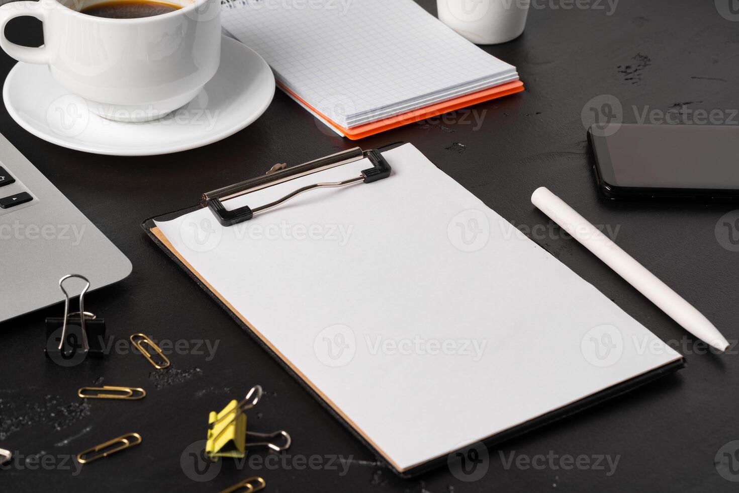 Clipboard mock up on home office workspace with coffee cup and stationery photo