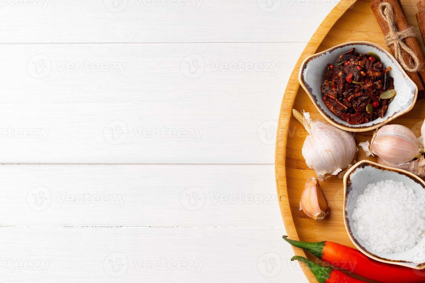 Various spices on white wooden background, close up. photo