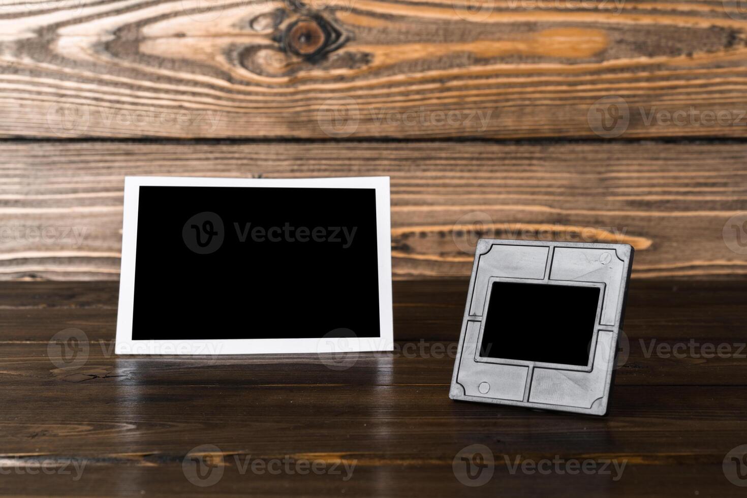 Blank photo frame on brown wooden background
