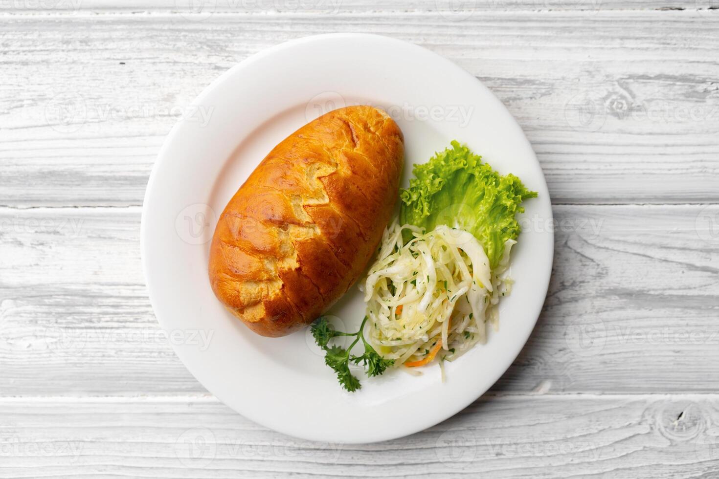 Traditional Russian pie or patty on white plate photo