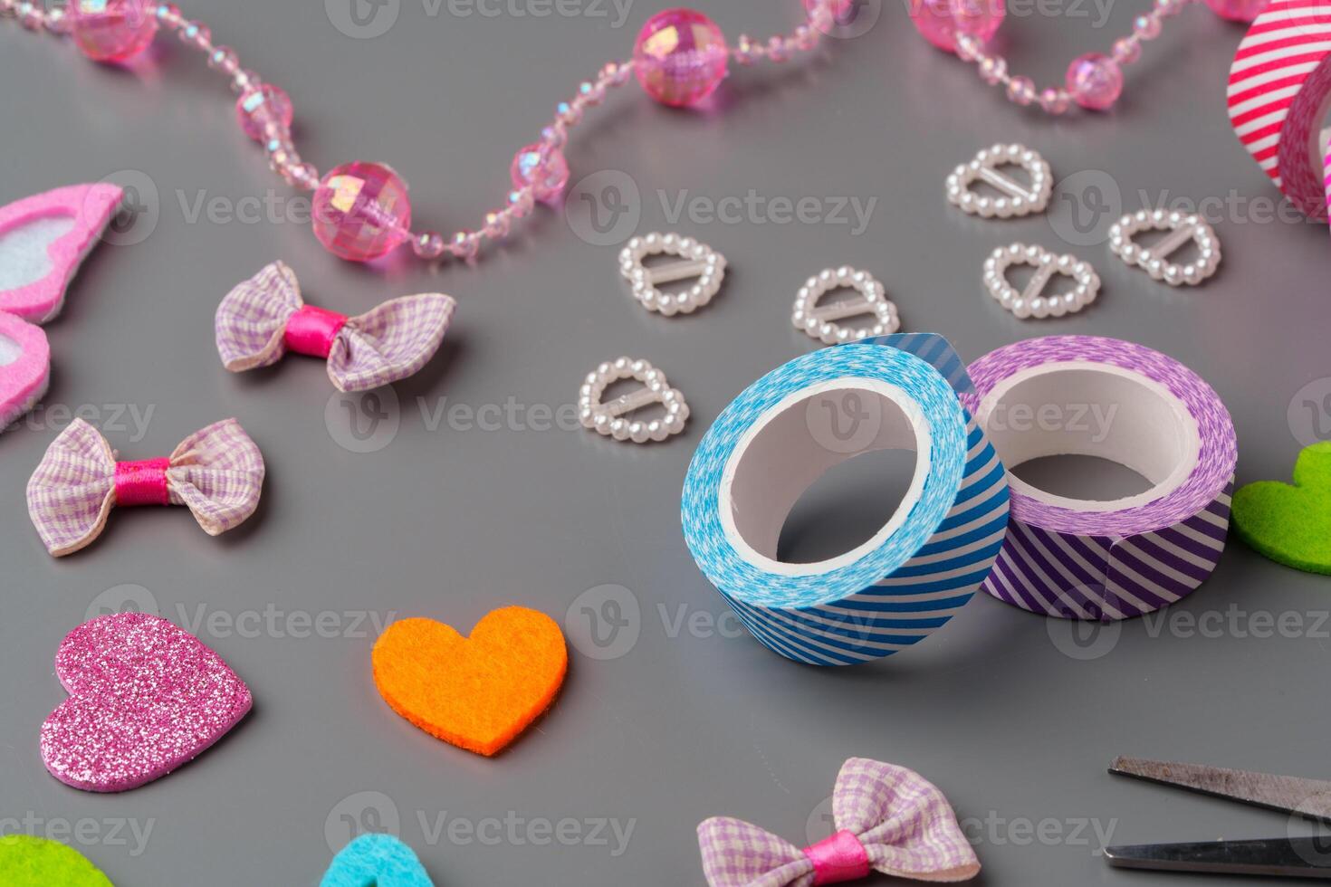 Crafting materials and tools arranged on a gray surface during a creative project photo