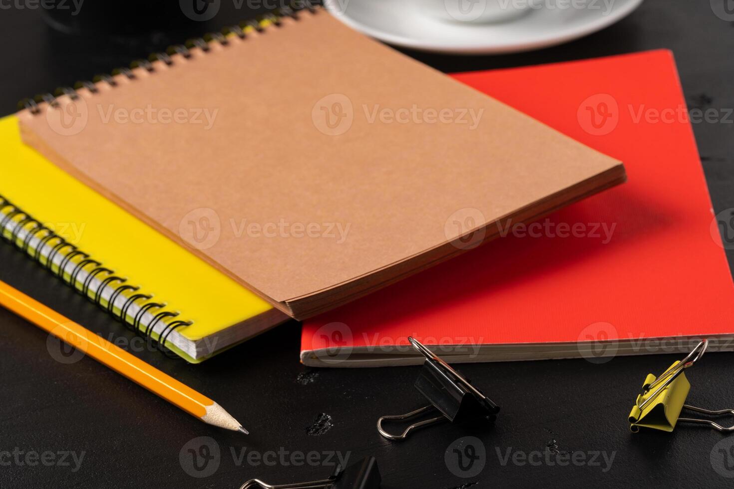 Three notepads on a black table close up photo