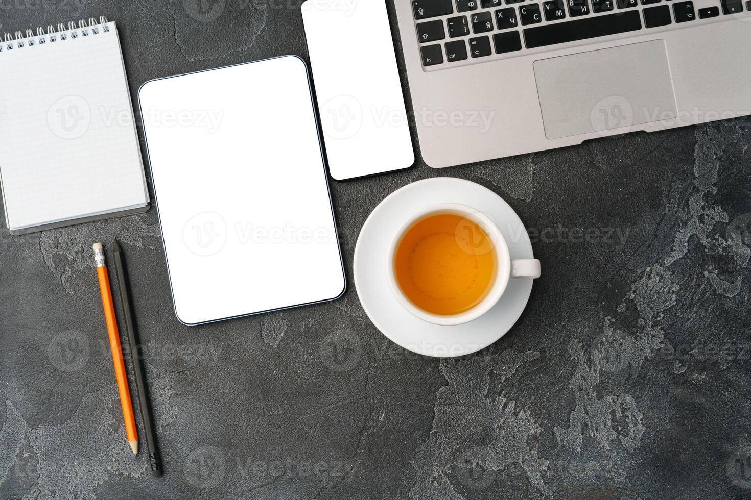 Digital tablet and coffee cup on gray table photo