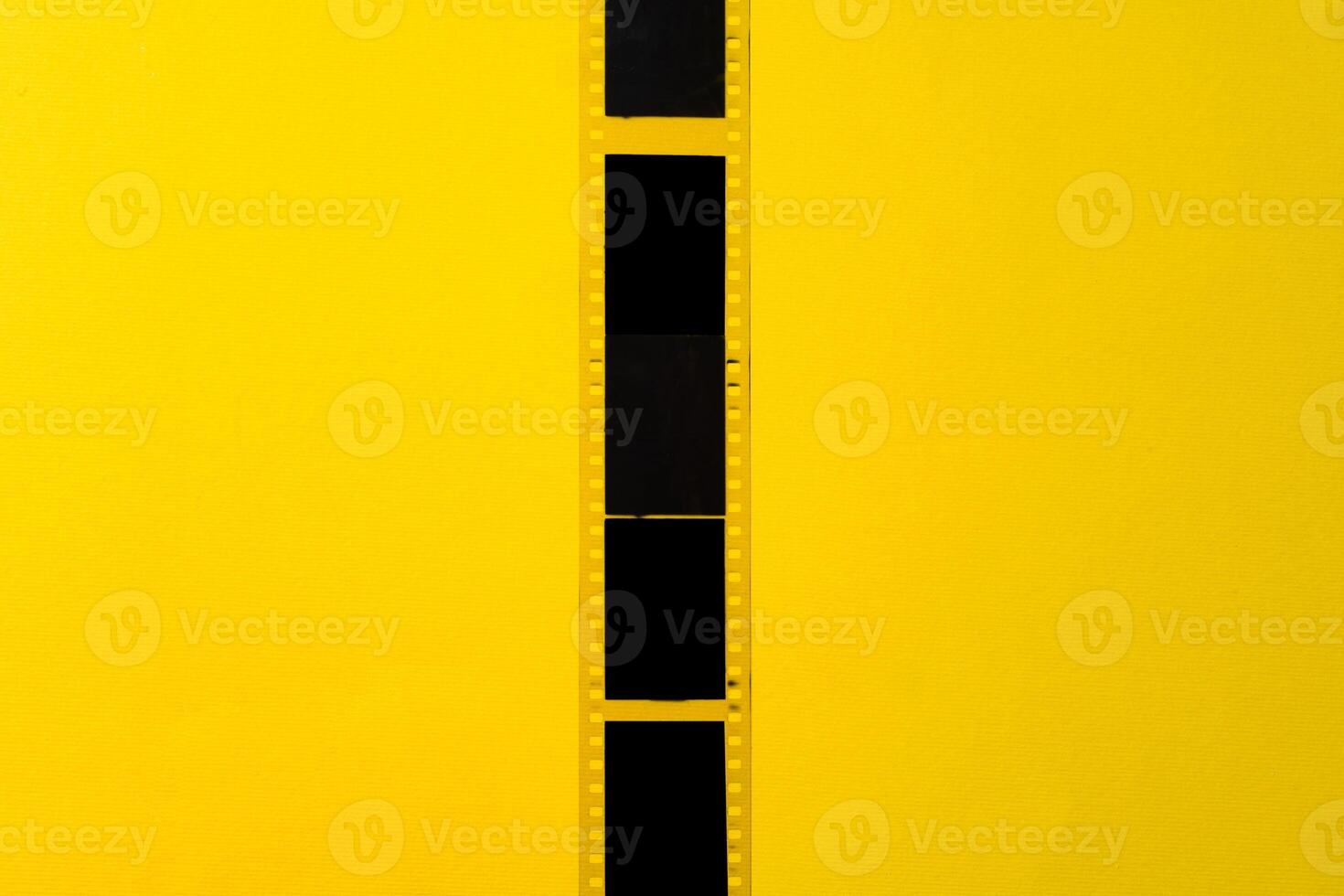 Old vintage film for a camera on yellow background photo