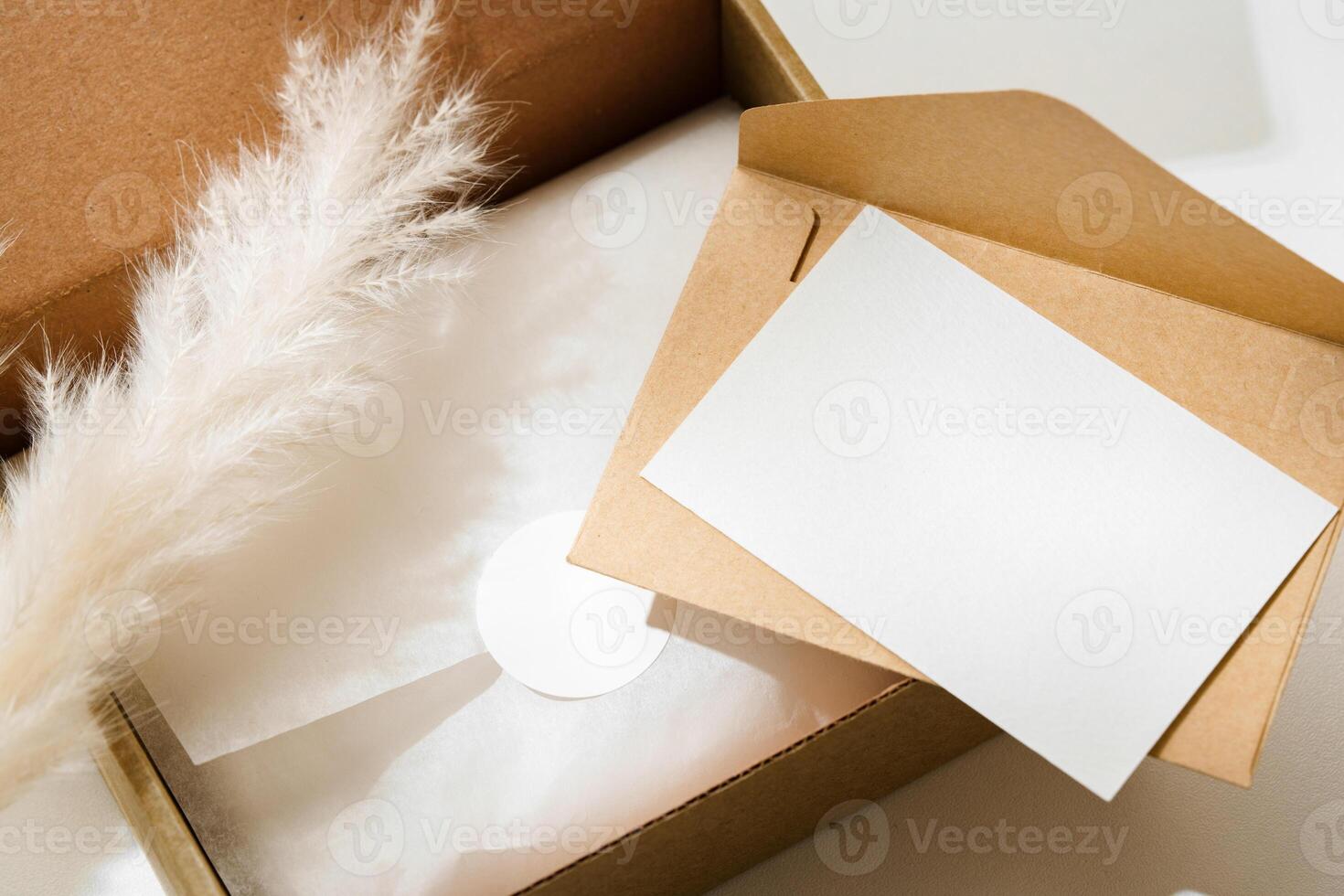 Delivery package with a blank envelope and decorative elements on a light background photo