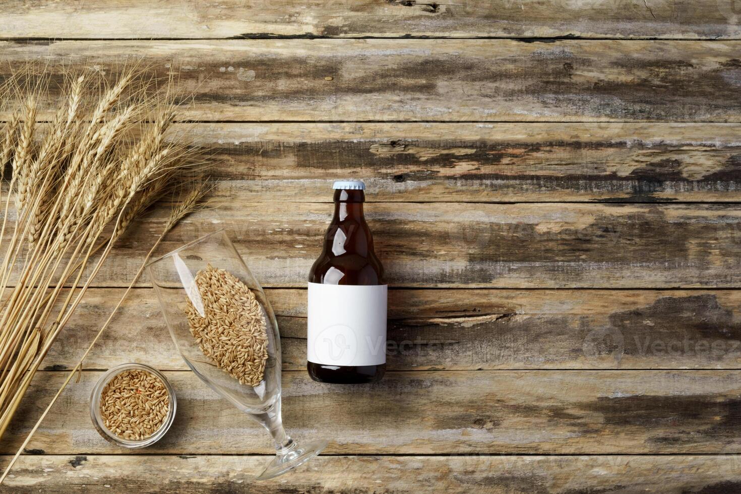 A bottle of beer and grain. Top view. Free space for text. photo