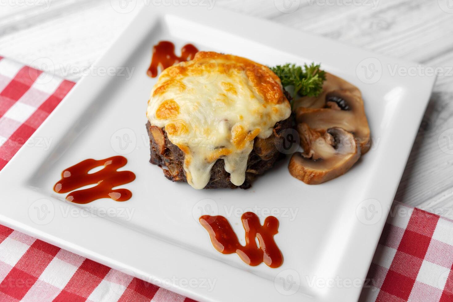 Delicious veal cutlet with melted mozzarella cheese on white plate photo
