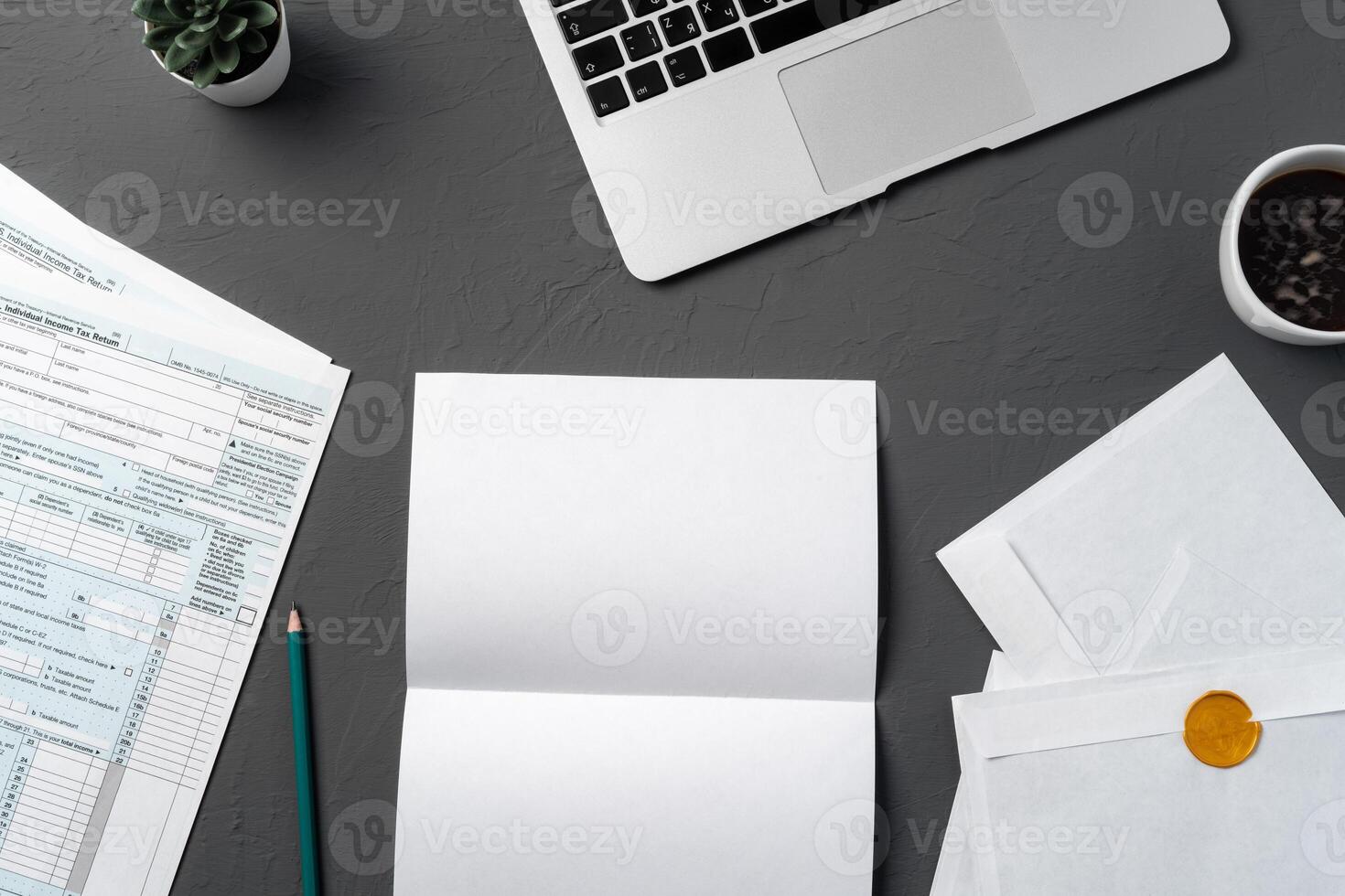 Mail envelope, coffee, pen and laptop on the desk. photo