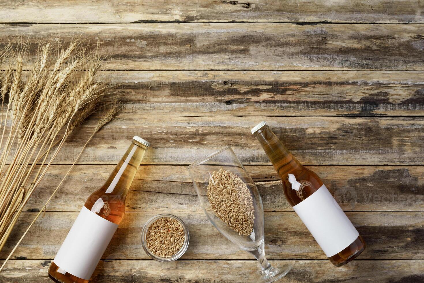 A bottle of beer and grain. Top view. Free space for text. photo