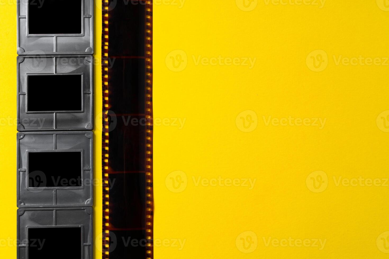 Photography empty slide frames on yellow background photo