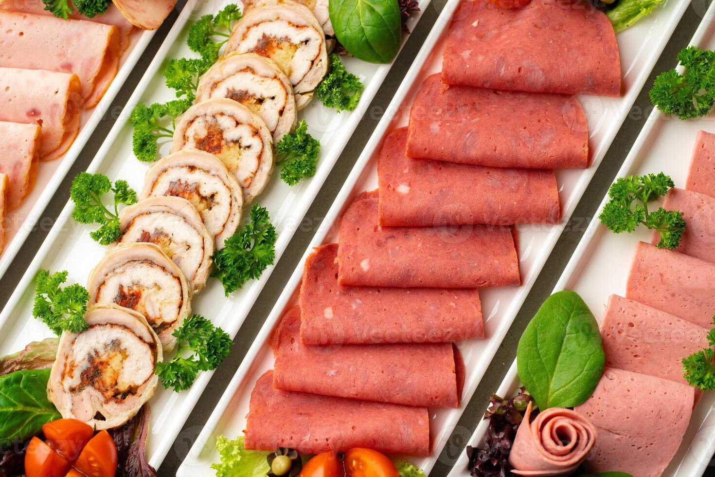 Platter of fresh meat cold cuts with vegetables. photo