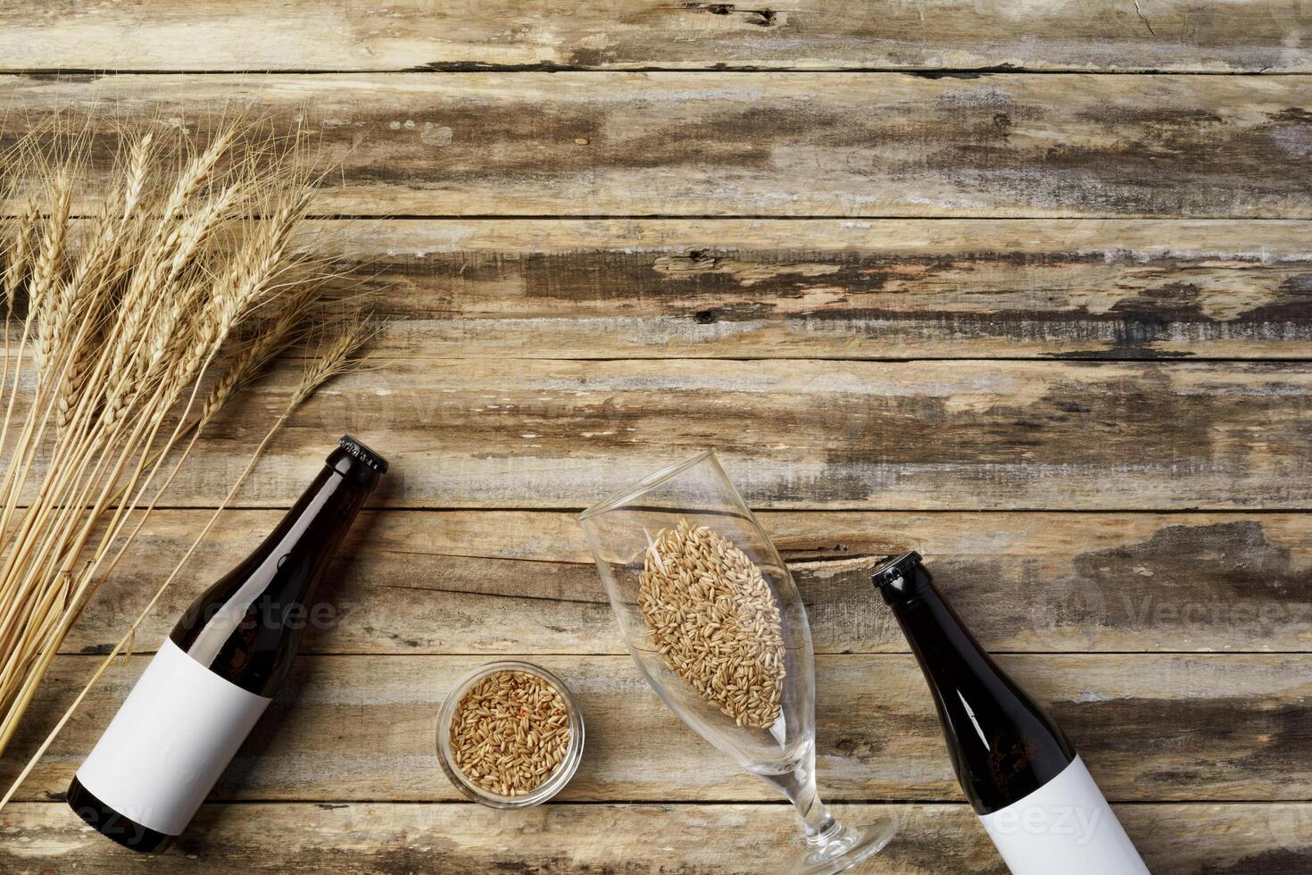A bottle of beer and grain. Top view. Free space for text. photo