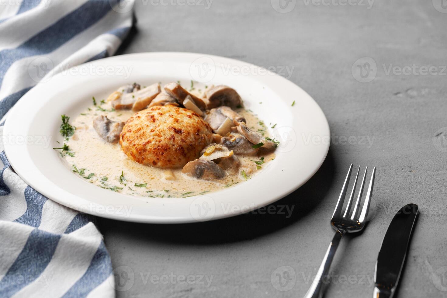 Delicious veal cutlet with melted mozzarella cheese on white plate photo