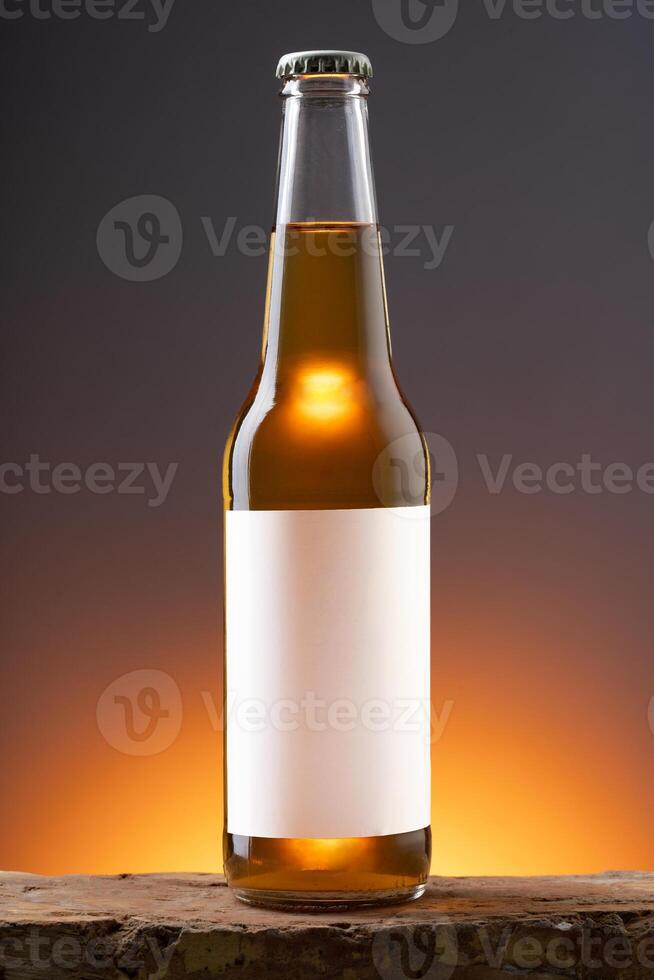 Blank label on the beer bottle on dark background. photo