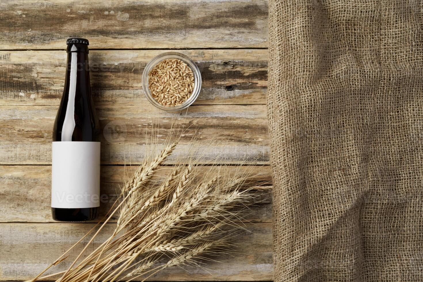 A bottle of beer and grain. Top view. Free space for text. photo