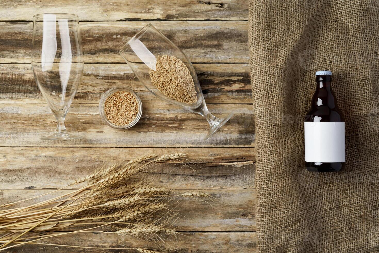 A bottle of beer and grain. Top view. Free space for text. photo