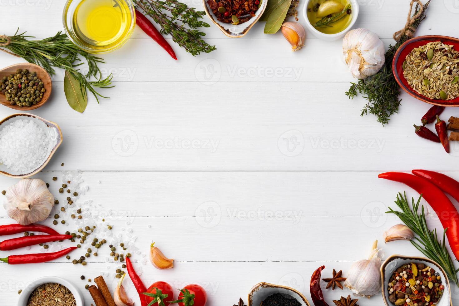 Olive oil and spices on kitchen table photo