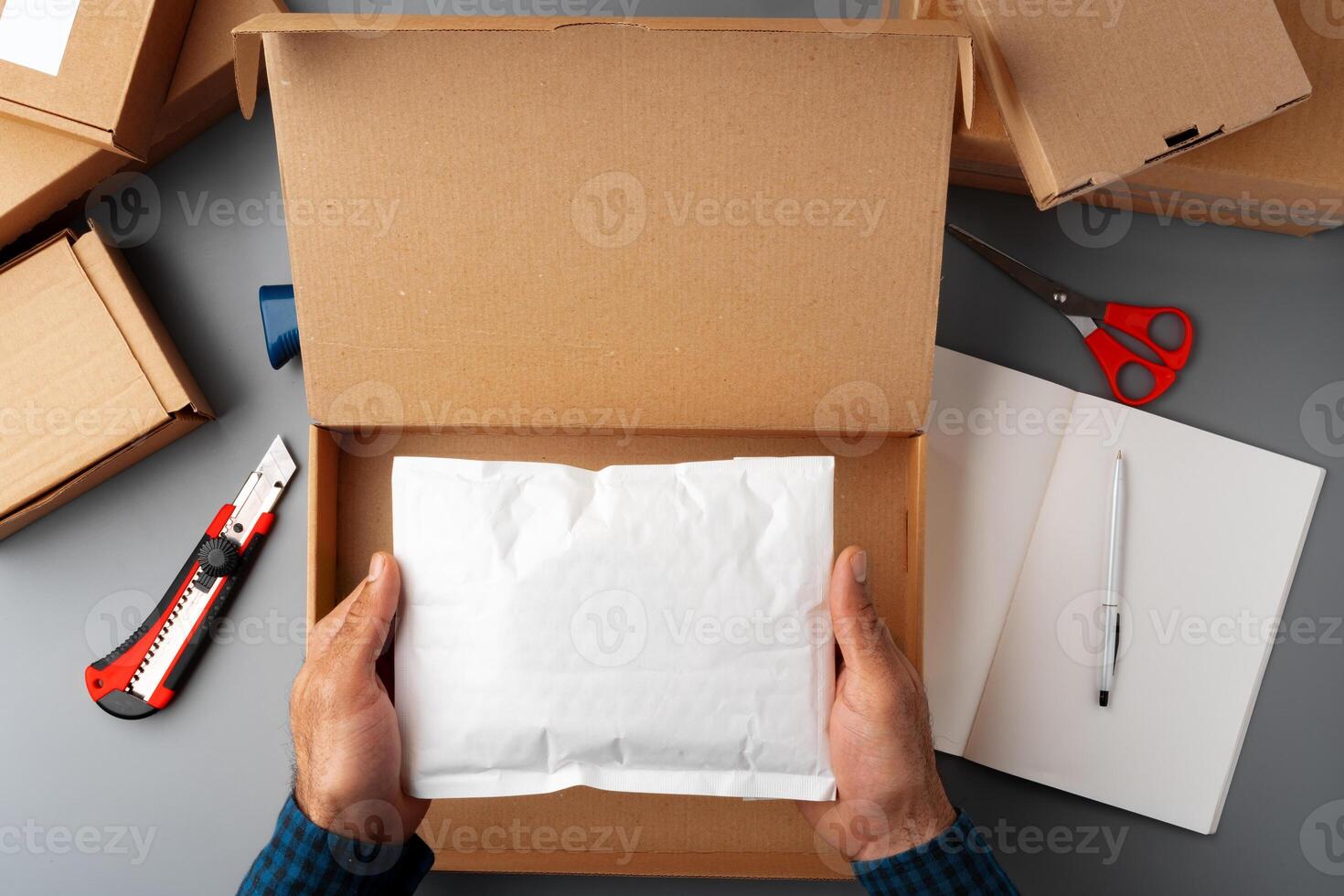 Above table top view of warehouse preparing post courier delivery package photo
