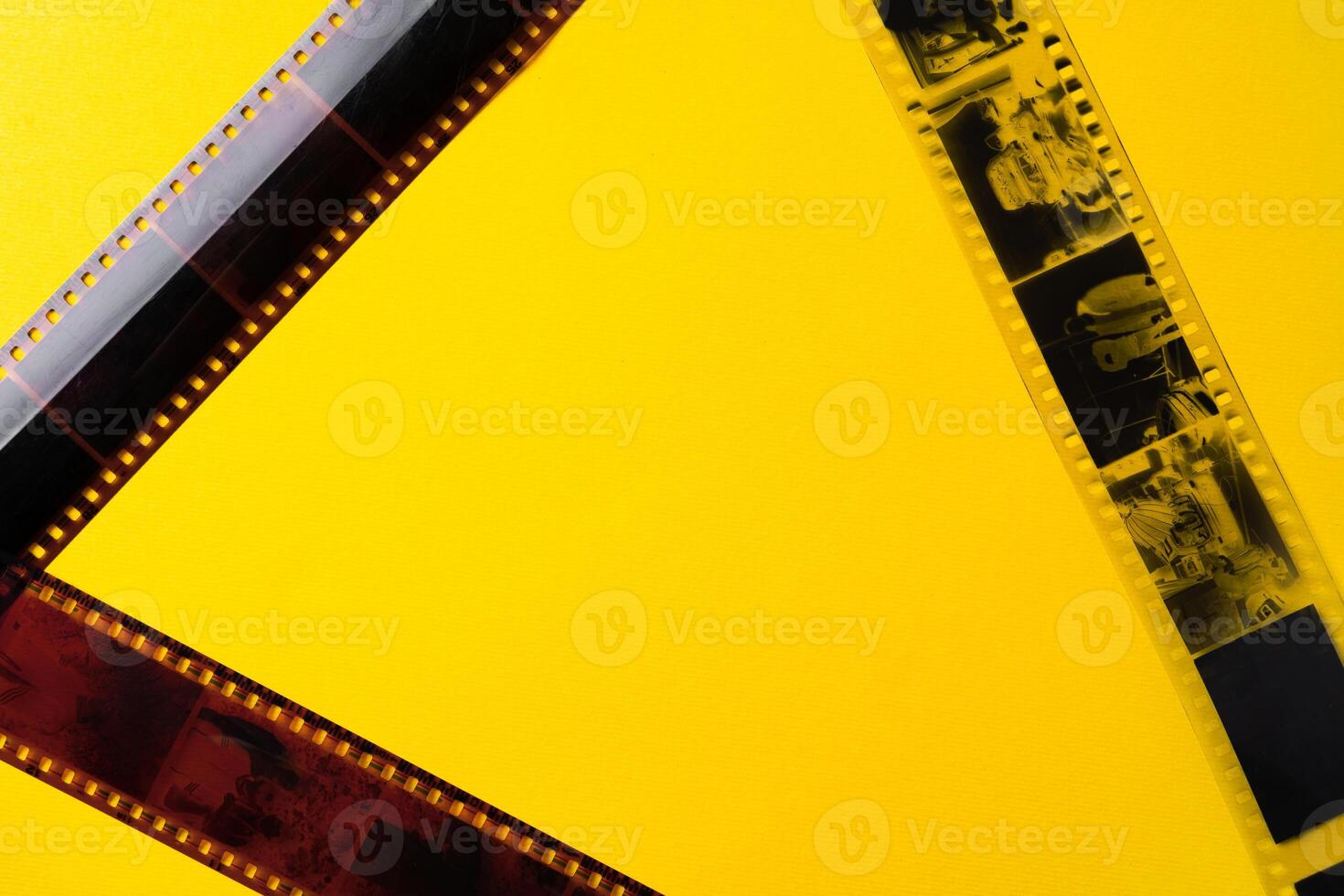 Old vintage film for a camera on yellow background photo