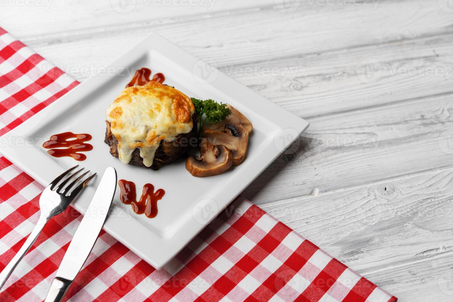 Delicious veal cutlet with melted mozzarella cheese on white plate photo