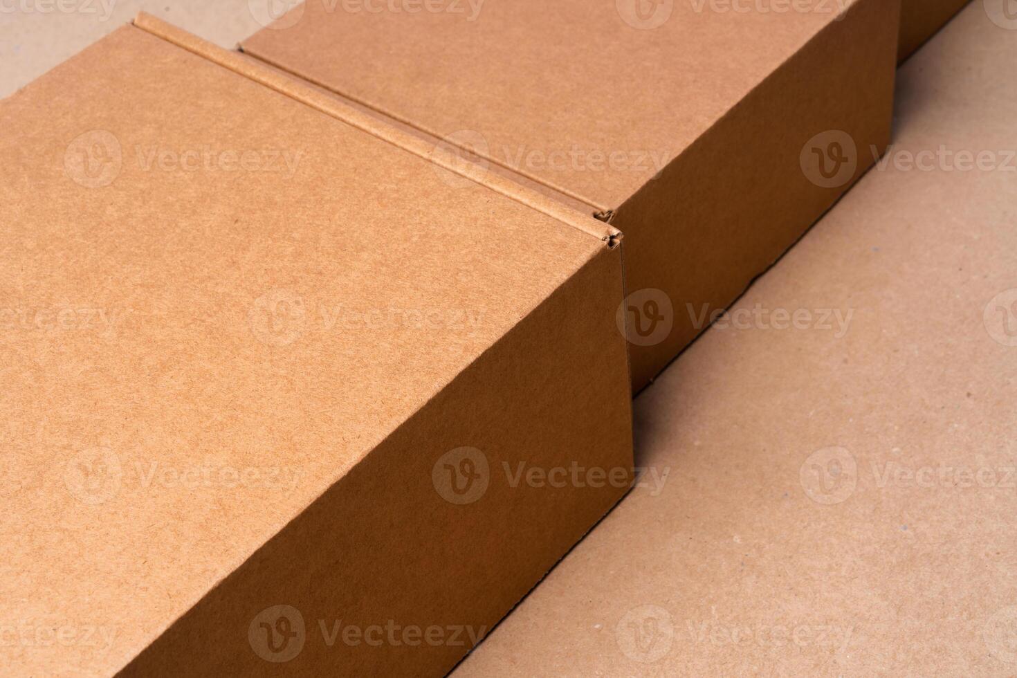 Cardboard box on beige background in studio photo
