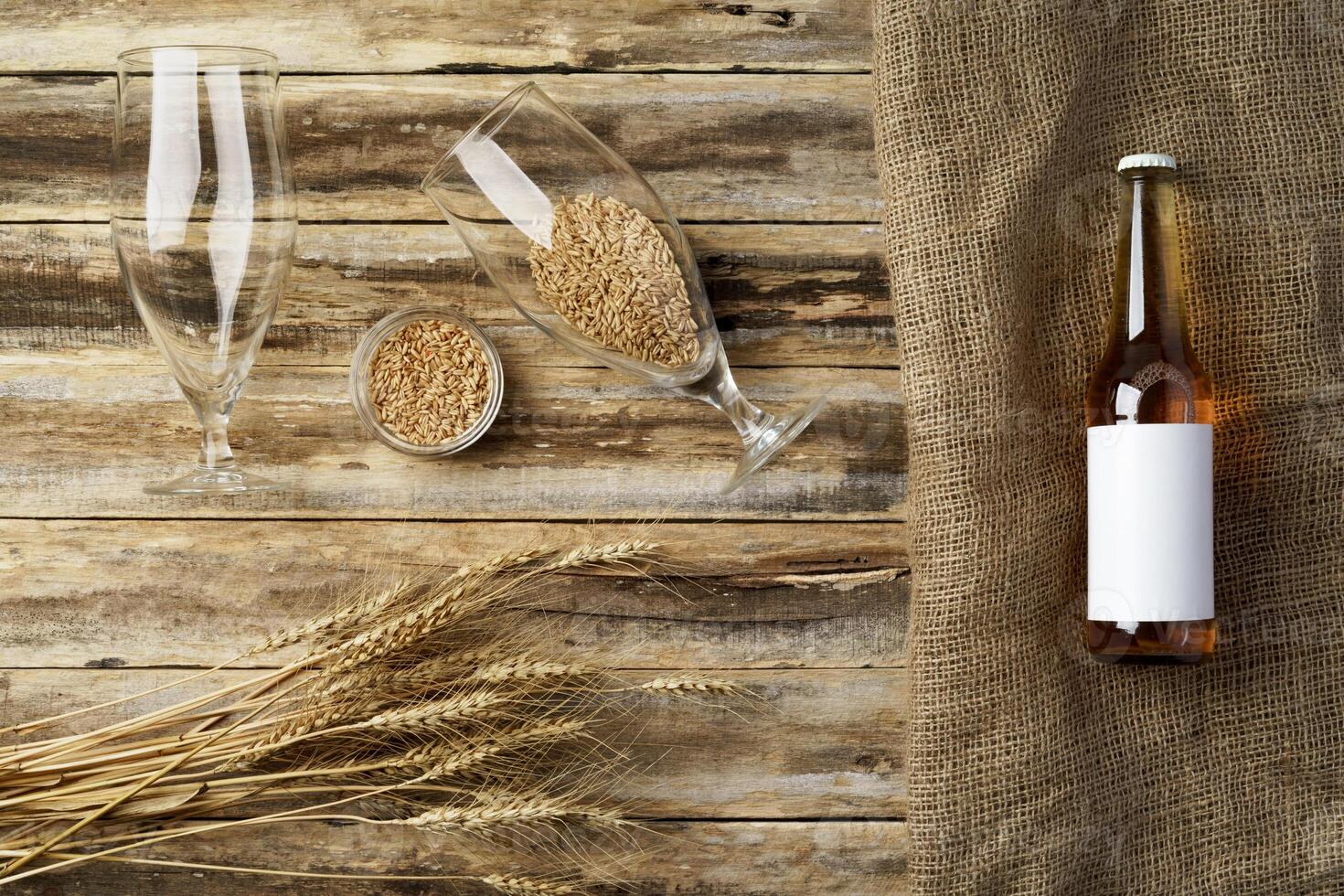 A bottle of beer and grain. Top view. Free space for text. photo