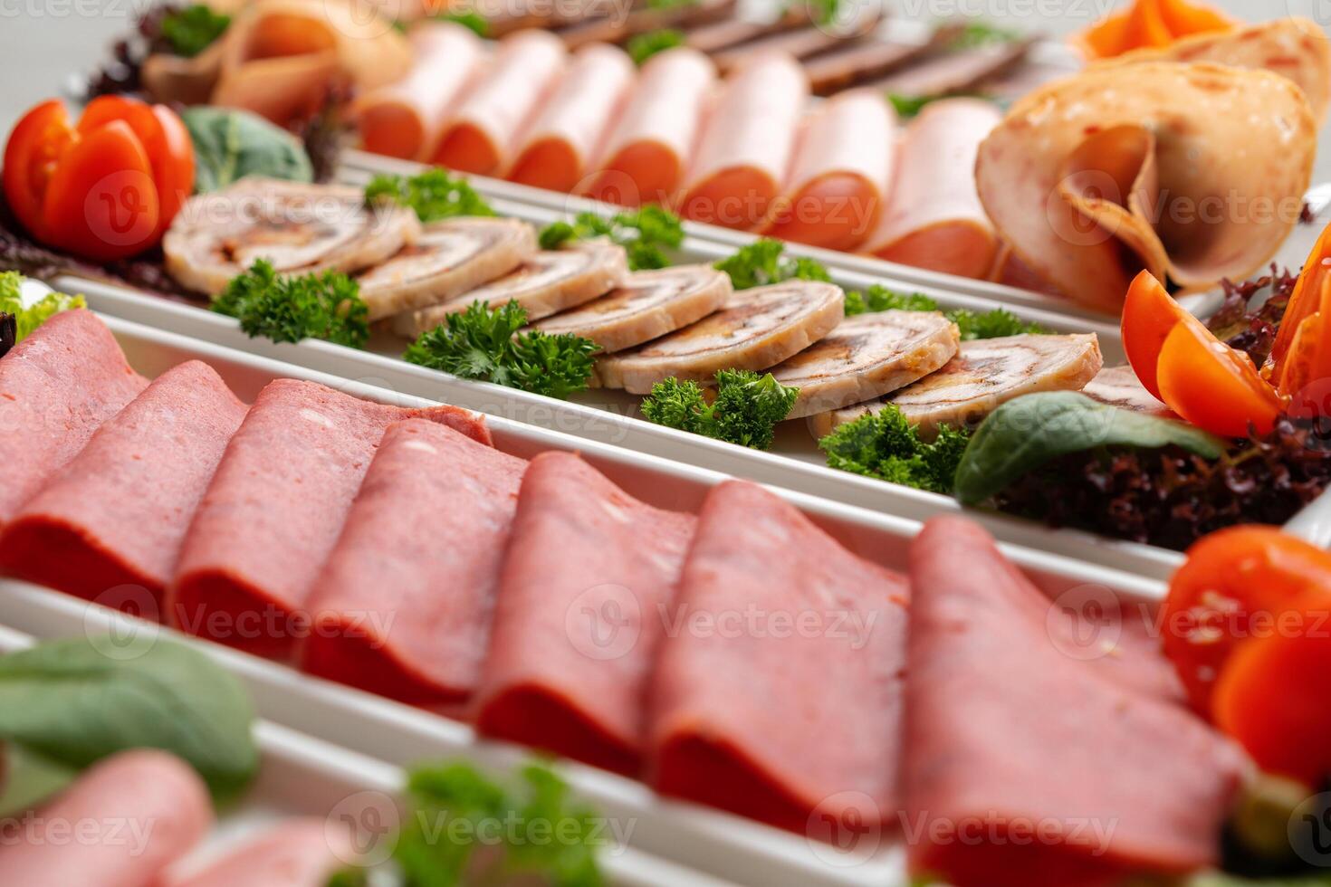 Platter of fresh meat cold cuts on table photo