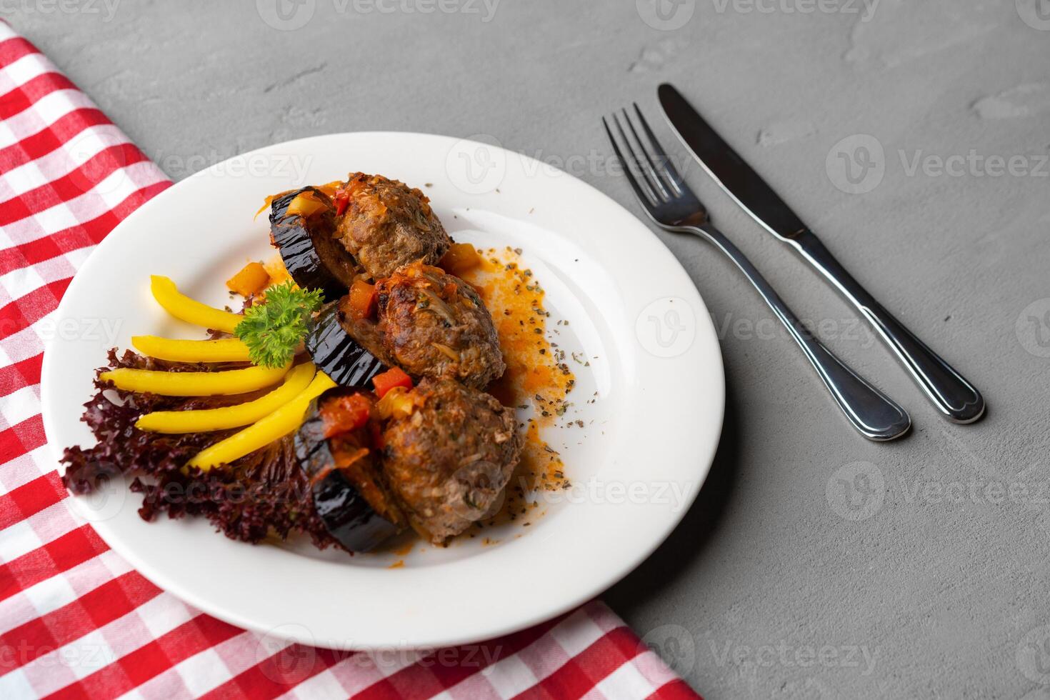 Cooked meat with fresh vegetable salad on a white plate photo