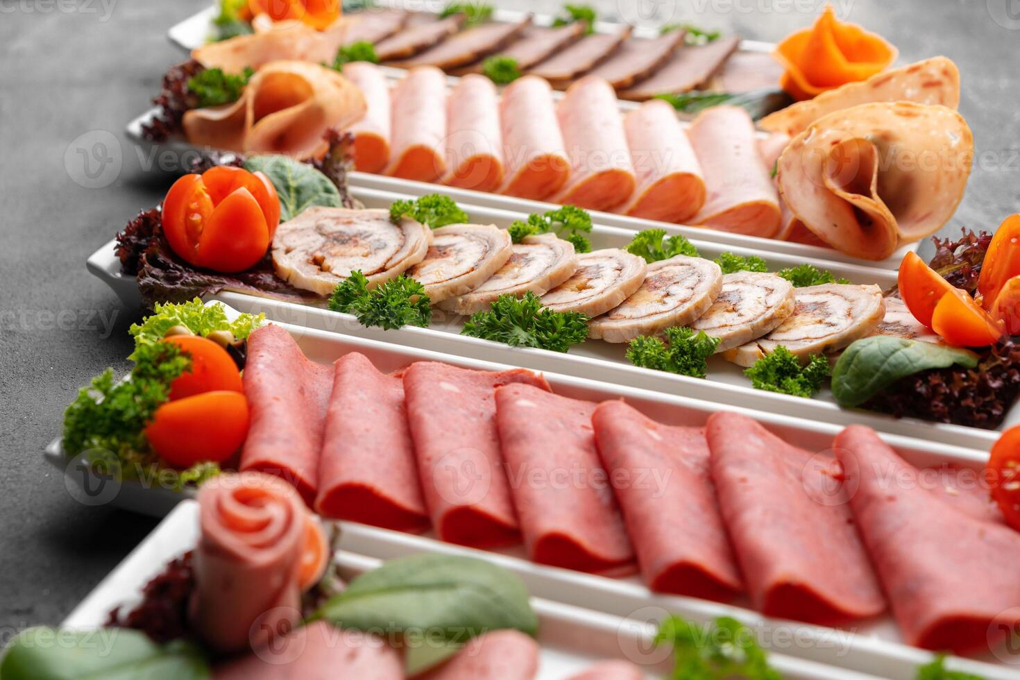 Platter of fresh meat cold cuts on table photo
