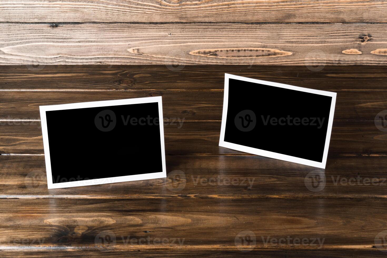 Blank photo frames for your photos on wooden background