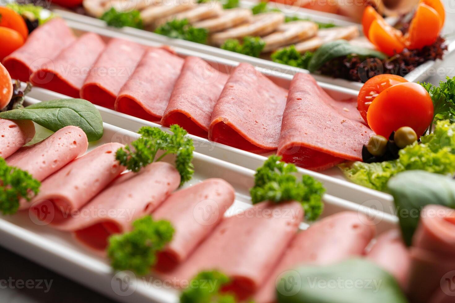 Platter of fresh meat cold cuts on table photo