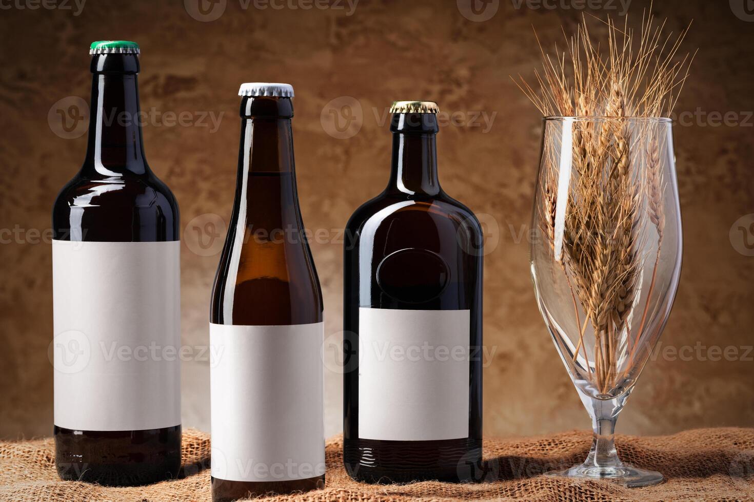 Beer bottle and beer glass against gray background photo