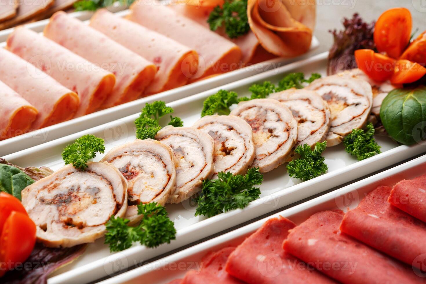 Platter of fresh meat cold cuts on table photo