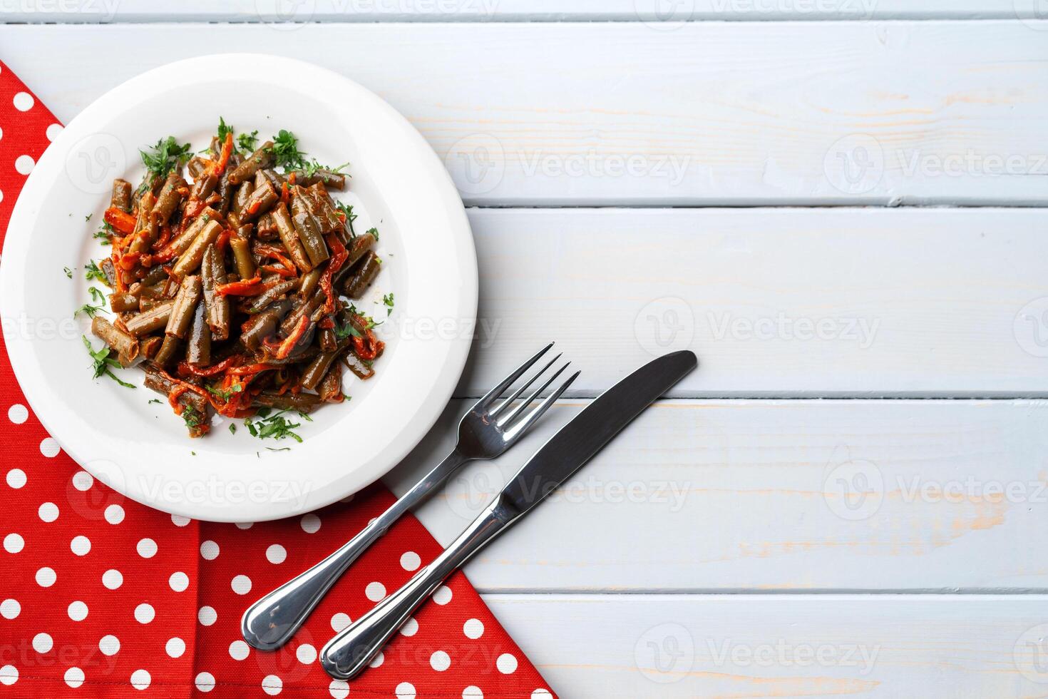 Oven baked vegetable salad on wooden background photo