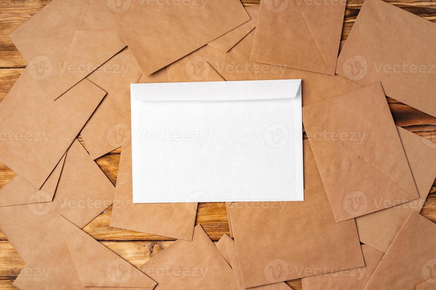 Stack of envelopes on working desk top view. Business mail photo